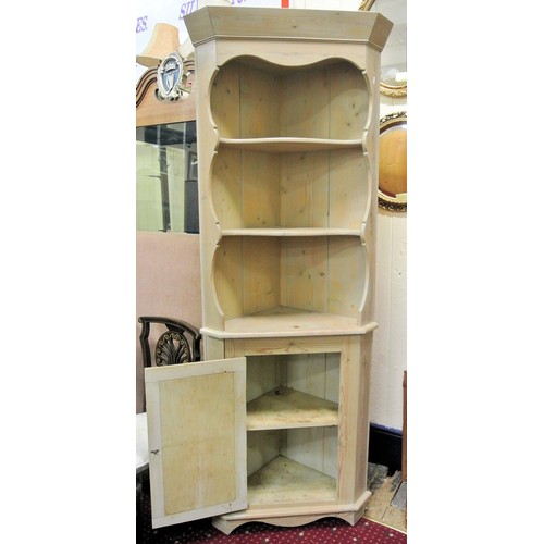 254 - Edwardian pine corner display cabinet with serpentine fronted shelves, press under with panelled doo... 