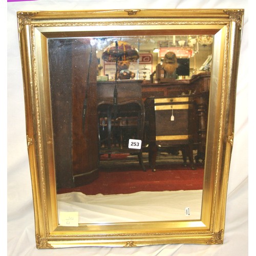 253 - Gilt framed wall mirror with ornate foliate decoration