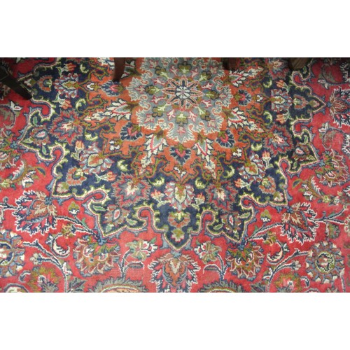 111 - Large red ground hand woven Persian Mashad carpet traditional floral design 395x 295cm