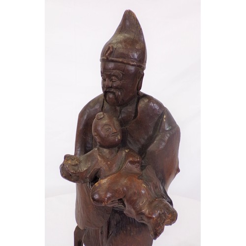 34 - Carved figure of an Asian man with child