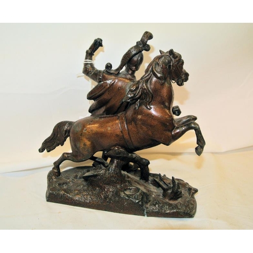 247 - Ornate bronzed group of soldier and horse, on foliate decorated oval base