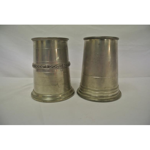 11 - Two pewter mugs of round tapering form with shaped handles