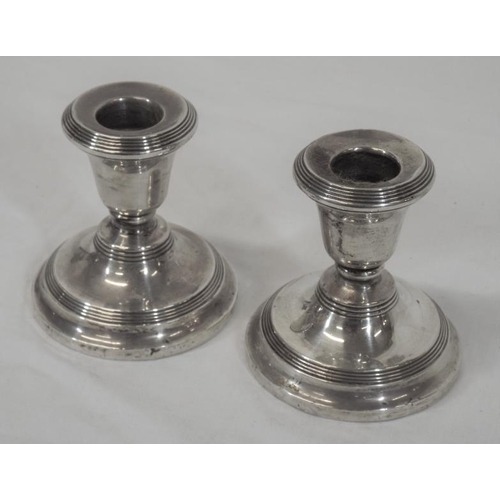 115 - Pair of Birmingham silver dwarf candlesticks with reeded rims, on spreading bases, dated 1925 Total ... 