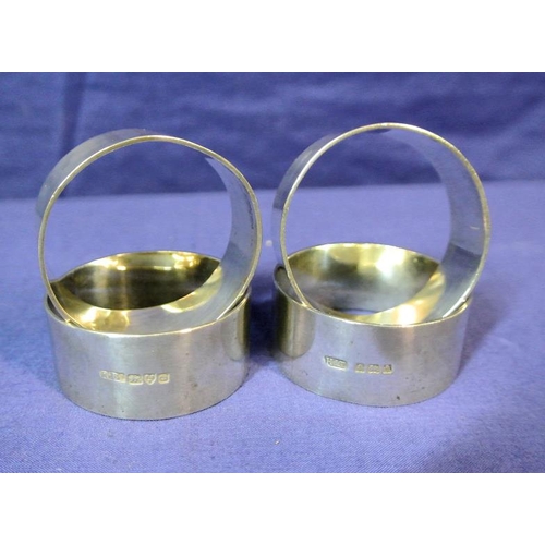 116 - Three Birmingham and one Chester silver round napkin rings, Birmingham 1908 and 1845 121g