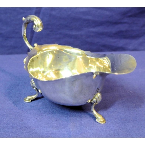 123 - Chester silver boat-shaped sauceboat with wavy rim, scroll handle, on three hoof feet with shell knu... 