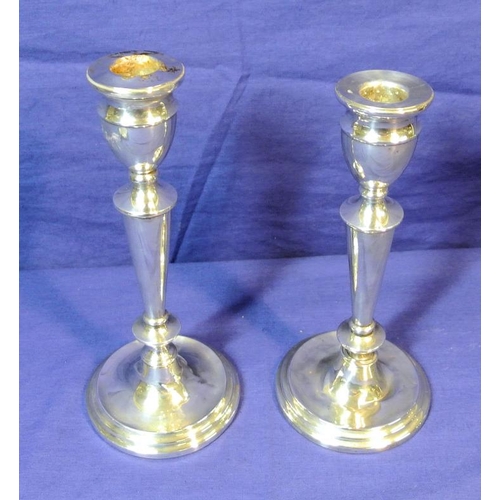 124 - Pair of Birmingham silver candlesticks with vase shaped tops, round tapering columns, on spreading b... 