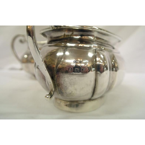 142 - Birmingham silver sugar bowl and cream jug of oval panelled form, with shaped scroll handles, dated ... 