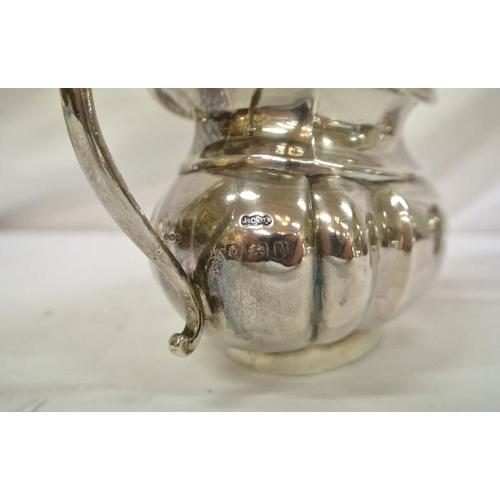 142 - Birmingham silver sugar bowl and cream jug of oval panelled form, with shaped scroll handles, dated ... 