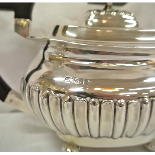 146 - Edward VII Sheffield silver three piece tea service of oval form, with reeded decoration, shaped han... 