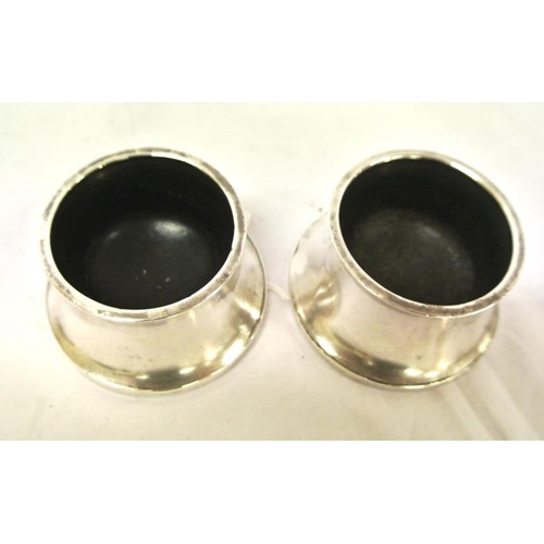 31 - Pair of round Birmingham silver mustard pots of concave tapering form, 112 grams