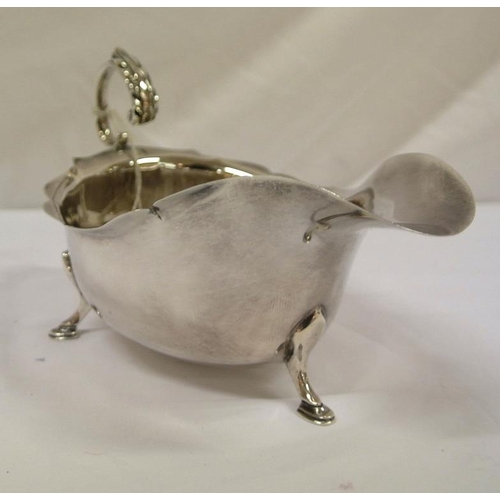 57 - Chester silver boat-shaped sauceboat with wavy rim, shaped handle and hoof feet, dated 1925, 142g