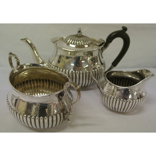 125 - Victorian London silver three piece tea service of oval form with reeded lower bodies, shaped handle... 