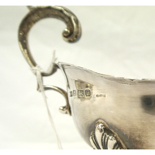 140 - Birmingham silver sauceboat with wavy rim, shaped scroll handle, on claw feet, dated 1939, 169g