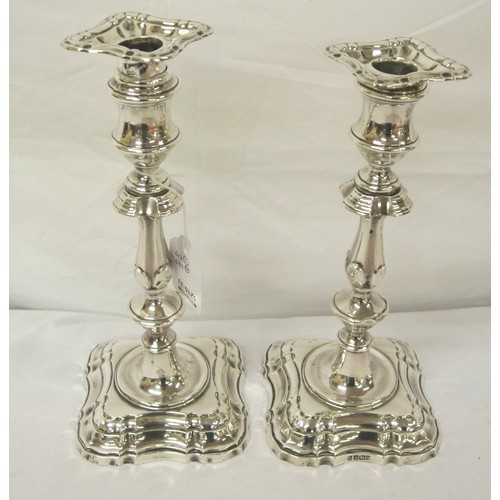 169 - Pair of Edward VII Sheffield silver candlesticks with detachable sconces, shaped columns, on shaped ... 