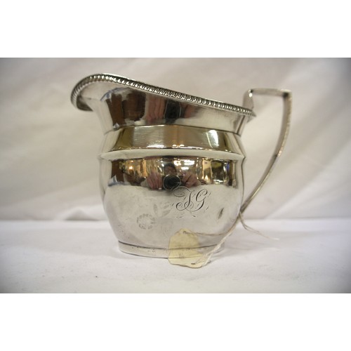 127 - Georgian London silver cream jug of oval bulbous form with gadroon rim, shaped handle, on stepped ba... 