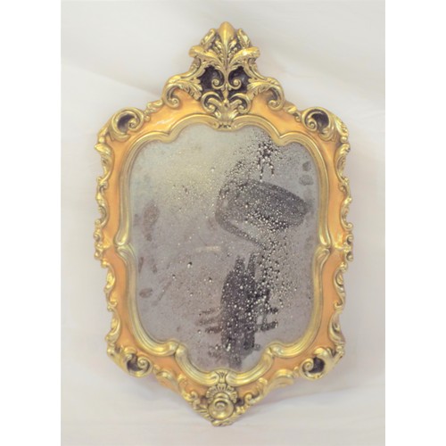 3 - Regency design gilt framed shaped wall mirror with ornate scroll decoration