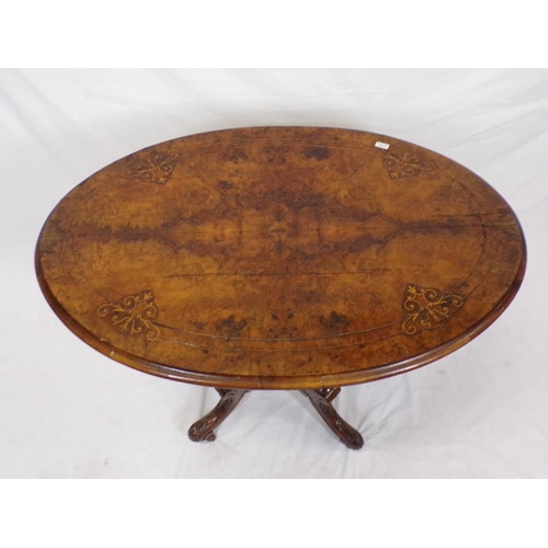 31 - Victorian oval walnut occasional table with ornate scroll and string inlay, on four turned shaped co... 