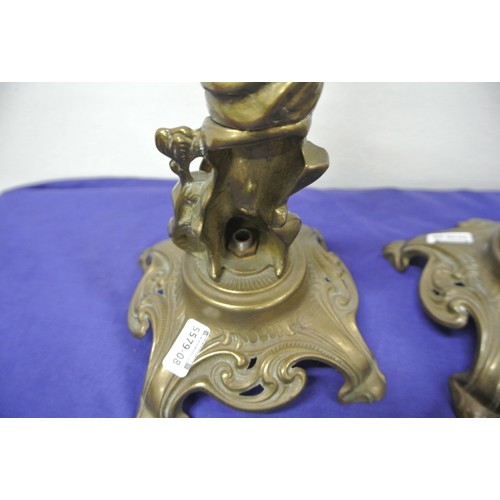 32 - Pair of ornate brass candlesticks, in the form of ladies on a figured seat, on shaped bases