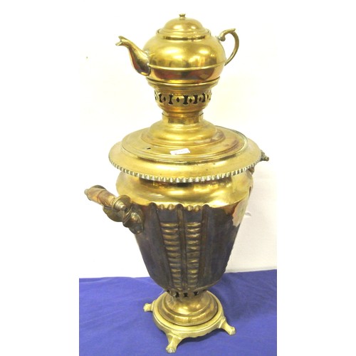 33 - Ornate Victorian style brass samovar with teapot on top, shaped handles and tap, on round base with ... 