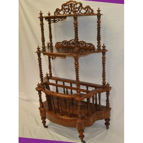 41 - Victorian walnut bow fronted three tier whatnot with ornate pierced fretwork back, turned finials, t... 