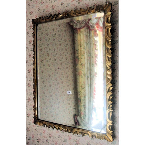 43 - Regency design gilt framed bevelled glass wall mirror with scroll decoration