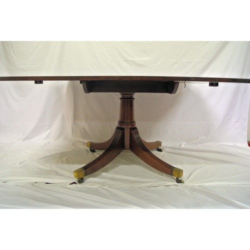 55 - Georgian mahogany library or dining table with tip-up top, rounded corners, raised on turned taperin... 