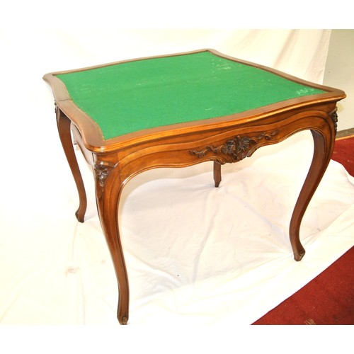 90 - Edwardian mahogany tea table with serpentine sided fold-over top, baize surface, foliate carving, on... 