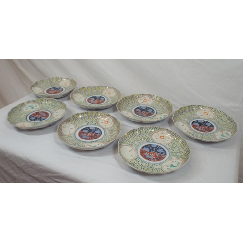 102 - Set of seven Imari plates with wavy rims, burnt ochre and deep blue and yellow foliate decoration