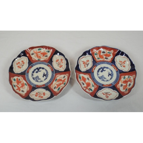 104 - Pair of circular Imari style wall plaques with wavy rims, burnt ochhre and deep blue foliate decorat... 