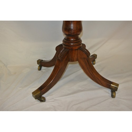 130 - William IV rosewood card table with swivel fold-over top, raised on vase turned shaped column, on fo... 