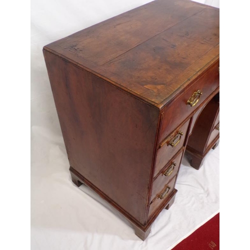 145 - Early Georgian walnut and rosewood kneehole desk with frieze drawer, six side drawers, brass drop ha... 