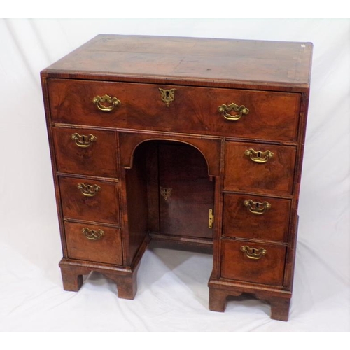 145 - Early Georgian walnut and rosewood kneehole desk with frieze drawer, six side drawers, brass drop ha... 