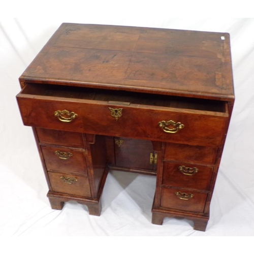 145 - Early Georgian walnut and rosewood kneehole desk with frieze drawer, six side drawers, brass drop ha... 