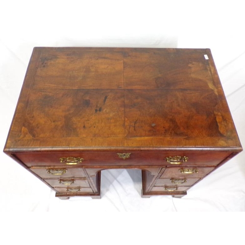 145 - Early Georgian walnut and rosewood kneehole desk with frieze drawer, six side drawers, brass drop ha... 