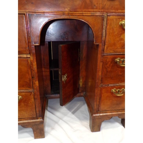 145 - Early Georgian walnut and rosewood kneehole desk with frieze drawer, six side drawers, brass drop ha... 