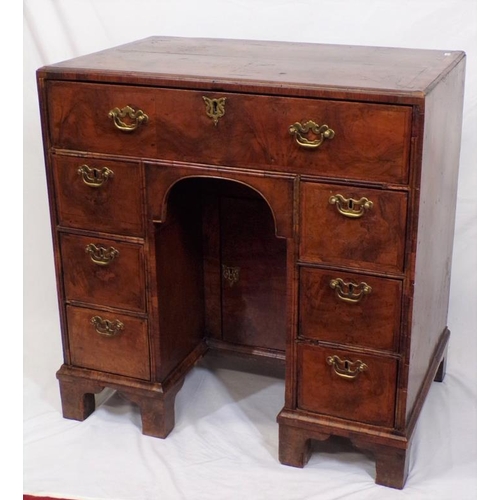 145 - Early Georgian walnut and rosewood kneehole desk with frieze drawer, six side drawers, brass drop ha... 