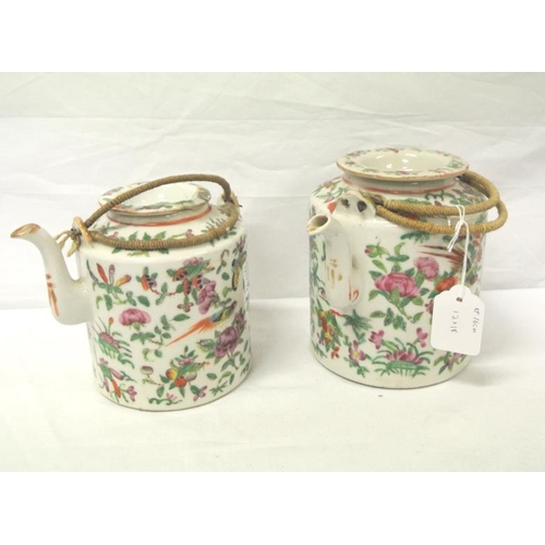 163 - Pair of Oriental Famille Rose teapots with shaped spouts, lids and ornate foliate bird decoration