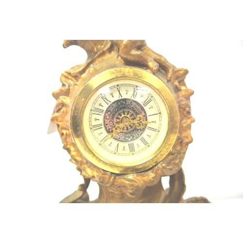 201 - French style ormolu mantel clock with cherub and foliate decoration, circular enamel dial, and shape... 