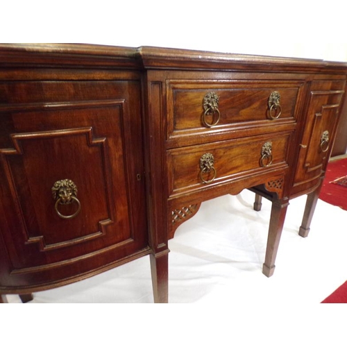 185 - Edwardian mahogany breakfront sideboard with two central drawers, side presses with ornate brass lio... 