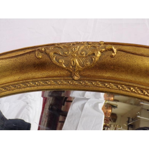 137 - Regency design oval bevelled glass gilt framed wall mirror with foliate decoration