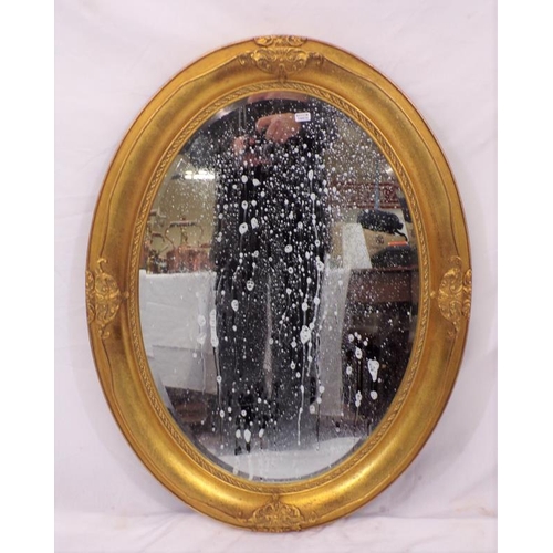 137 - Regency design oval bevelled glass gilt framed wall mirror with foliate decoration