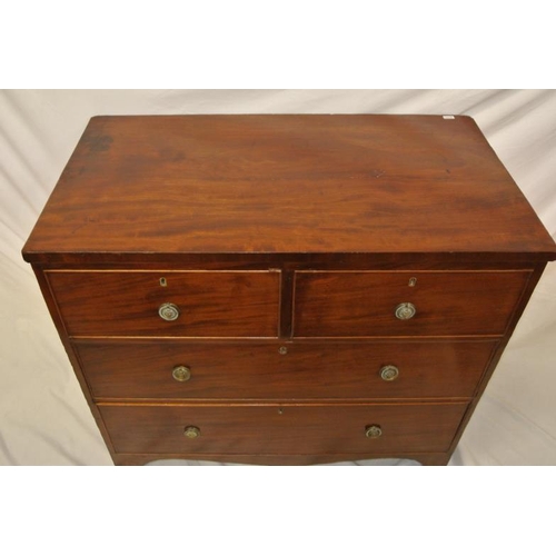 181 - Georgian mahogany chest of two short and two long drawers with ornate brass drop handles, on bracket... 