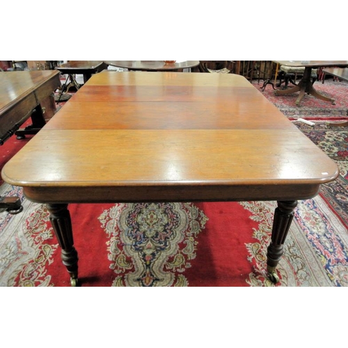 210 - Victorian mahogany extending dining table with rounded borders, two extra leaves inset, raised on fi... 