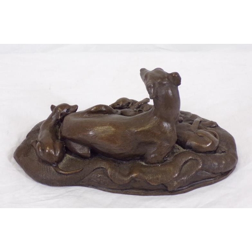 213 - Ornate bronzed group of a dog with puppies, on shaped base