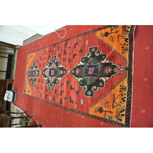 221 - Washed red ground vintage Iranian village runner wth large medallion desing and animal motifs