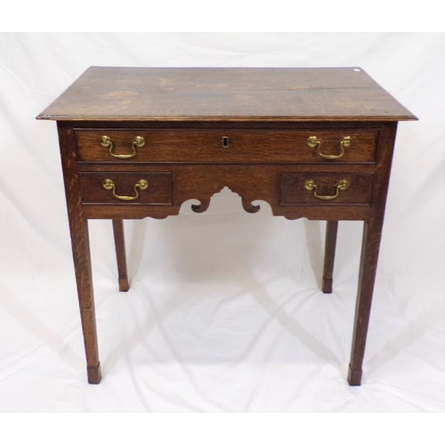 75 - Georgian oak lowboy with frieze drawer, two lower drawers, shaped apron, brass drop handles, on squa... 