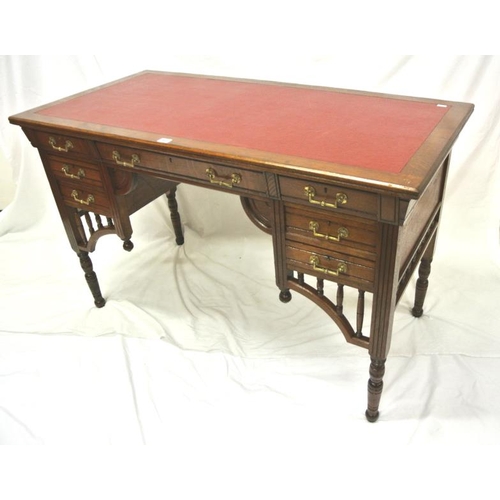 95 - Edwardian oblong desk with leatherette inset, three frieze and four side drawers with ornate brass d... 