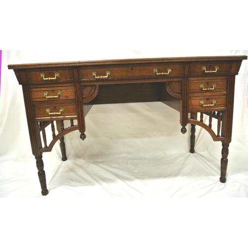 95 - Edwardian oblong desk with leatherette inset, three frieze and four side drawers with ornate brass d... 