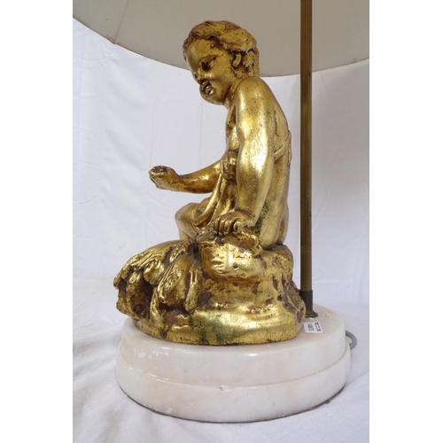 27 - Electric table lamp with ornate gilded figure, on round marble base