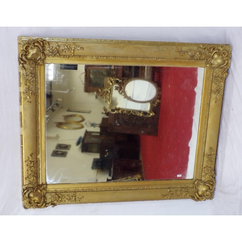 48 - Large gilt framed wall mirror with ornate scroll and foliate decoration